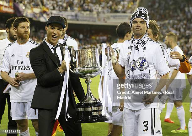 Cristiano Ronaldo and Pepe of Real Madrid celebrate with the trophy after the Copa del Rey Final between Real Madrid and Barcelona at Estadio...