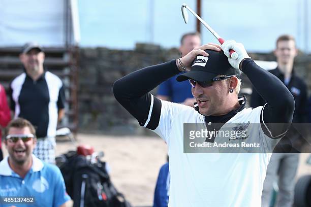 Stefan Kretzschmar hits a tee shot during the 'RTL - Wir helfen Kindern' Golf Charity 2015 tournament at Golf Club Oberberg on August 24, 2015 in...