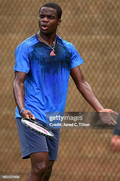 Frances Tiafoe reacts after a ball hit by James Duckworth of Australia was called in during the first day of the Winston-Salem Open at Wake Forest...