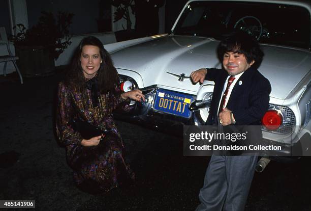 Actor Herve Villechaize attends an event with a woman and his car that has the license plate OOTTAT a play on his name "Tatu" from the TV show...