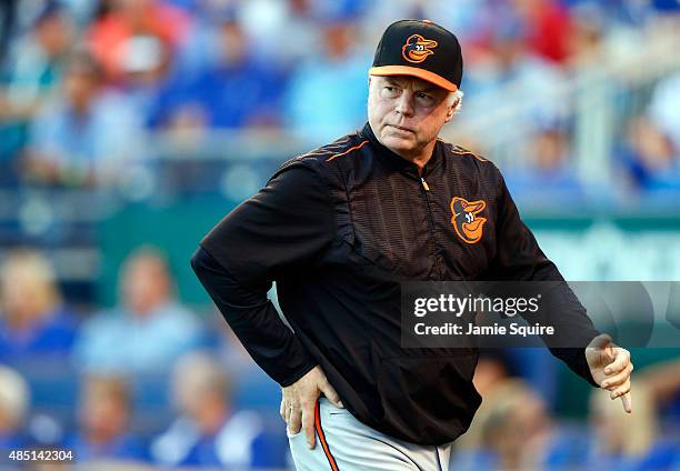 Manager Buck Showalter of the Baltimore Orioles walks back to the dugout after discussing with umpires a Manny Machado hit that was ruled a...