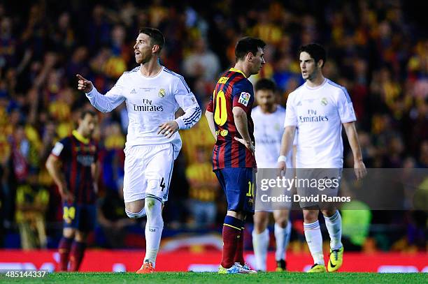 Sergio Ramos of Real Madrid CF celebrates past Lionel Messi of FC Barcelona after his teammate Gareth Bale of Real Madrid CF scored the winning goal...