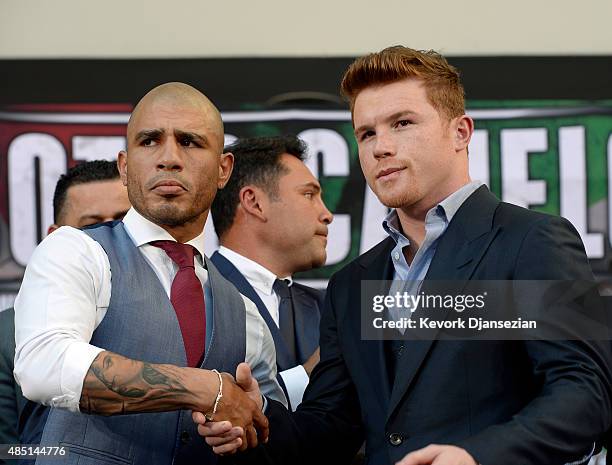 Current WBC champion Miguel Cotto and contender Canelo Alvarez pose after a news conference to announce their upcoming bout on August 24 in Los...