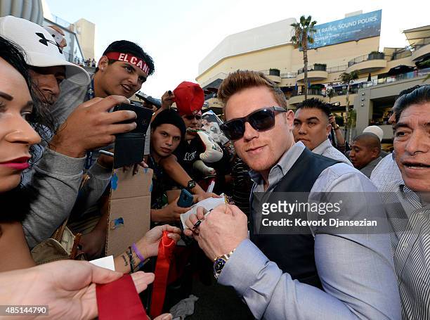 Boxer Canelo Alvarez poses with fans after a news conference to announce his next fight against current WBC champion Miguel Cotto August 24 in Los...