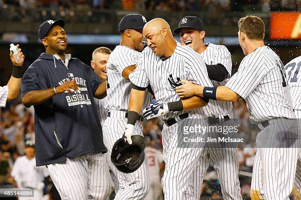 Carlos Beltran of the New York Yankees celebrates his ninth inning game winning sacrifice fly against the Houston Astros with his teammates at Yankee...