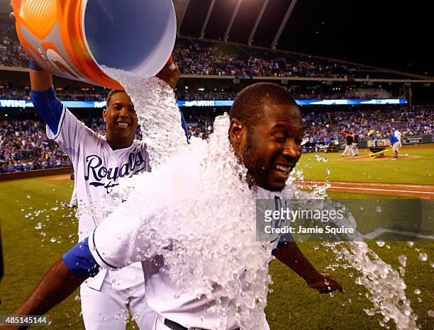 Lorenzo Cain of the Kansas City Royals is doused with water by Salvador Perez after the Royals defeated the Baltimore Orioles 8-3 to win the game at...