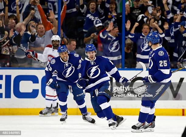 Nikita Kucherov of the Tampa Bay Lightning celebrates his goal between teammates J.T. Brown and Matt Carle as P.K. Subban of the Montreal Canadiens...