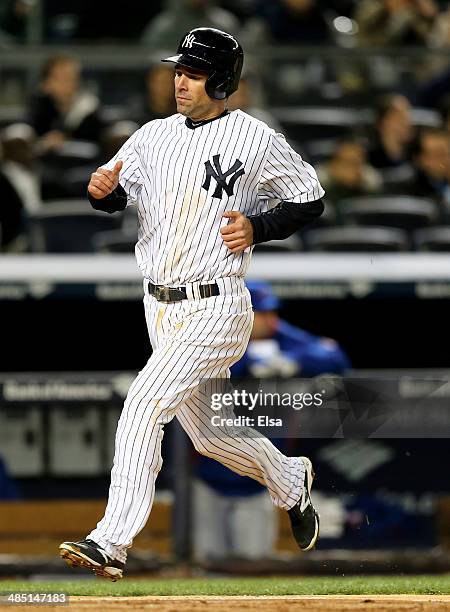 Scott Sizemore of the New York Yankees scores a run in the fourth inning against the Chicago Cubs during game two of a doubleheader on April 16, 2014...