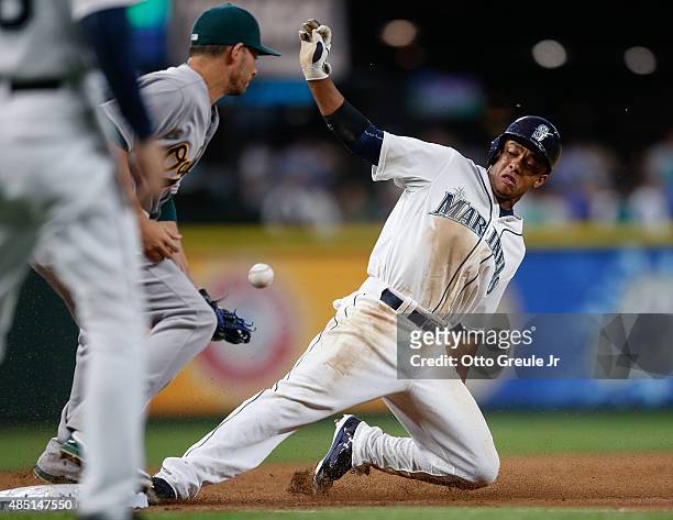 Ketel Marte of the Seattle Mariners steals third base against Danny Valencia of the Oakland Athletics in the third inning at Safeco Field on August...