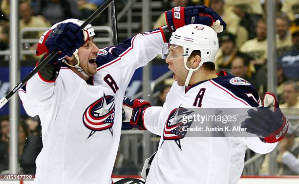 Jack Johnson celebrates with Brandon Dubinsky of the Columbus Blue Jackets against the Pittsburgh Penguins in Game One of the First Round of the 2014...