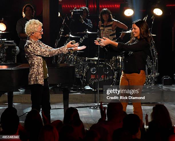 Singer/Songwriter Kevin Cronin of REO Speedwagon and singer/songwriter Sara Evans perform on stage during the CMT Crossroads taping of REO Speedwagon...