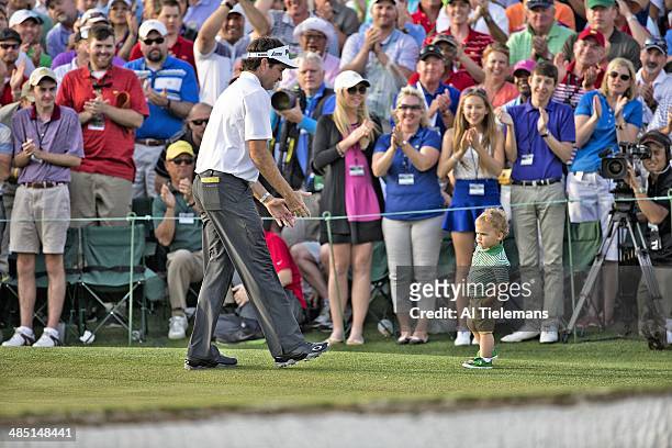 Bubba Watson victorious with his son Caleb Watson on No 18 gree after winning tournament on Sunday at Augusta National. Augusta, GA 4/13/2014 CREDIT:...