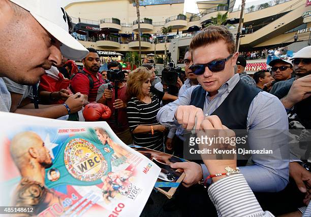 Boxer Canelo Alvarez, former WBC and WBA Super Welterweight World Champion, signs posters after a news conference to announce his next bout against...