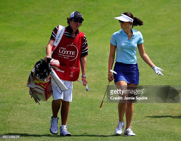 Michelle Wietalsk with caddie Duncan French as they walk up the 17th fairway during the first round of the LPGA LOTTE Championship Presented by J...