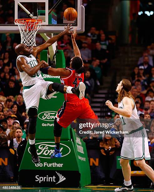 Nene of the Washington Wizards goes up for a shot in front of Joel Anthony of the Boston Celtics in the second quarter during the game at TD Garden...