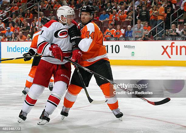 Drayson Bowman of the Carolina Hurricanes battles against Kimmo Timonen of the Philadelphia Flyers on April 13, 2014 at the Wells Fargo Center in...