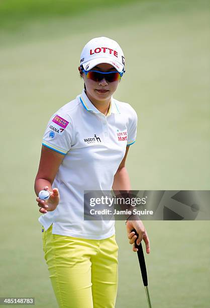 Hyo Joo Kim of South Korea waves to the crowd after sinking a pputt on the 17th hole during the first round of the LPGA LOTTE Championship Presented...