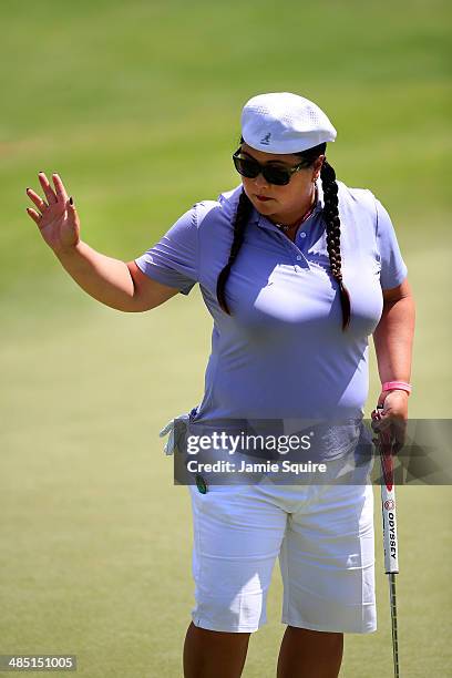 Christina Kim waves to the crowd after making a putt on the 17th hole during the first round of the LPGA LOTTE Championship Presented by J Golf on...