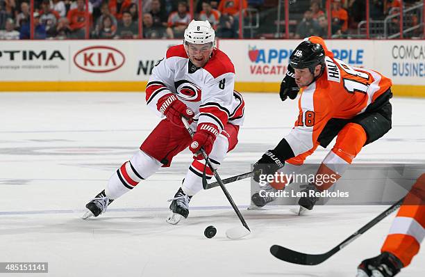 Adam Hall of the Philadelphia Flyers battles for the puck against Andrei Lokitonov of the Carolina Hurricanes on April 13, 2014 at the Wells Fargo...