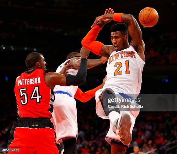 Iman Shumpert of the New York Knicks loses possession of the ball against Patrick Patterson of the Toronto Raptors in the first half during an NBA...