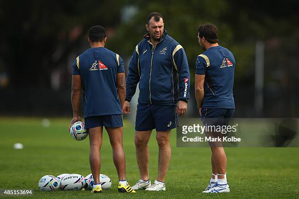 Wallabies coach Michael Cheika speaks to Will Genia and Nick Phipps during an Australian Wallabies training session at the Tramways Oval, Moore Park...