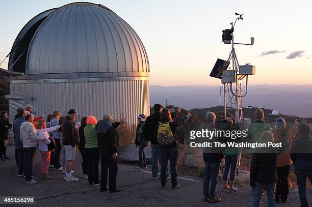 Kitt Peak National Observatory, Arizona - Participants in a nightly observation program watch sunset from a ridge on the 6,880-foot Kitt Peak. The...