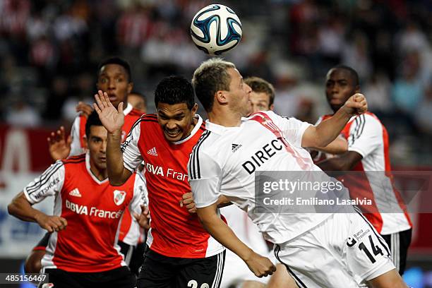 Teofilo Guti?rrez of River Plate hit the ball over Ignacio Domaste of Estudiantes during a match between Estudiantes and River Plate as part of 14th...