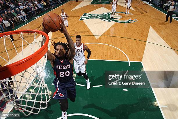 Cartier Martin of the Atlanta Hawks dunks against Jeff Adrien of the Milwaukee Bucks on April 16, 2014 at the BMO Harris Bradley Center in Milwaukee,...