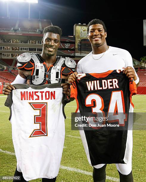 Runningback James Wilder, Jr. #32 of the Cincinnati Bengals and Quarterback Jameis Winston of the Tampa Bay Buccaneers pose for a photo with each...
