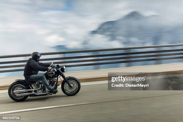 harley davidson rider in the alps - harley davidson motorcycles stock pictures, royalty-free photos & images