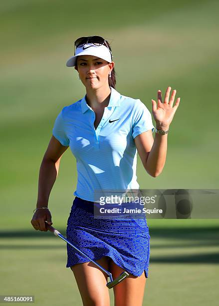 Michelle Wie waves to the crowd after putting for a birdie on the 7th hole during the first round of the LPGA LOTTE Championship Presented by J Golf...