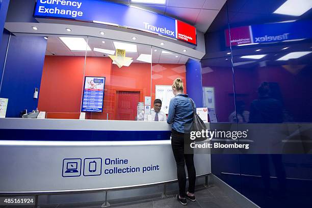 Customer changes currency at a Travelex UK Ltd. Currency exchange in London, U.K., on Monday, Aug. 24, 2015. European stocks rallied with U.S....