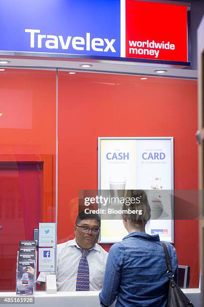 Customer changes currency at a Travelex UK Ltd. Currency exchange in London, U.K., on Monday, Aug. 24, 2015. European stocks rallied with U.S....