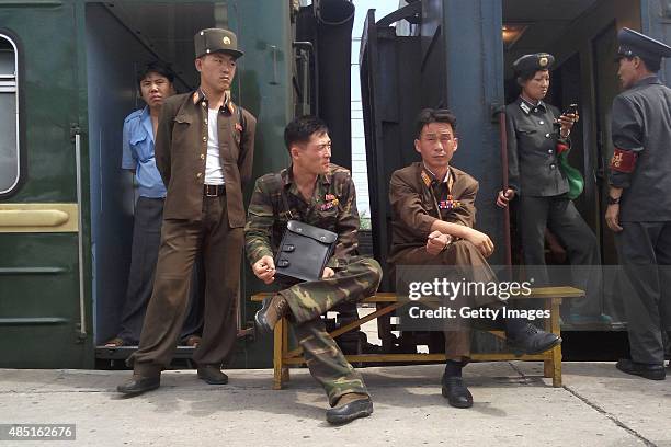 Korean People's Army soldiers take a rest at Hamhung Railway Station during a train journey amidst tension between North Korea and South Korea on...