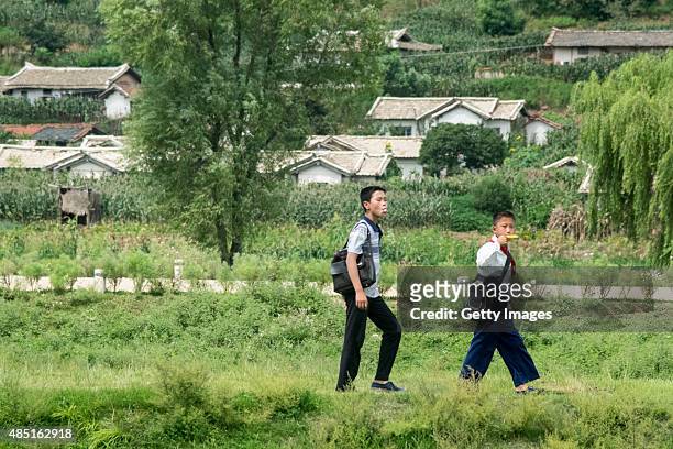Students walk home after school on August 24 North Korea. North and South Korea today came to an agreement to ease tensions following an exchange of...