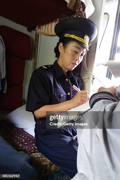 Quarantine official records passenger information on the train No.100 from Moscow to Pyongyang at Tumangang railway station on August 19, 2015 in...