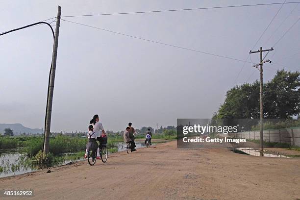 People go to work in the morning on August 20, 2015 in Tumangang, North Korea. North and South Korea today came to an agreement to ease tensions...