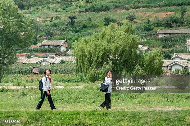 Students walk home after school on August 24 North Korea. North and South Korea today came to an agreement to ease tensions following an exchange of...