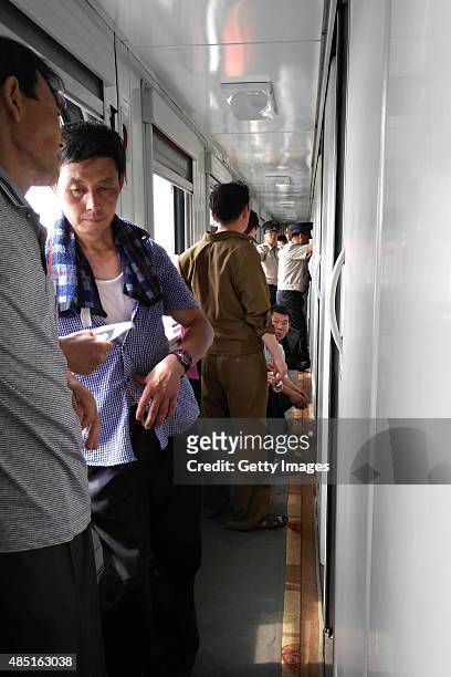 Passengers wait to be checked on the train No.100 from Moscow to Pyongyang at Tumangang railway station on August 19, 2015 in Tumangang, North Korea....