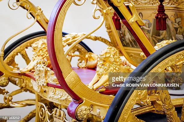 Photo taken on August 25, 2015 shows a view of a lion detail on the Golden Carriage in the museum at the Palace Het Loo in Apeldoorn, the...