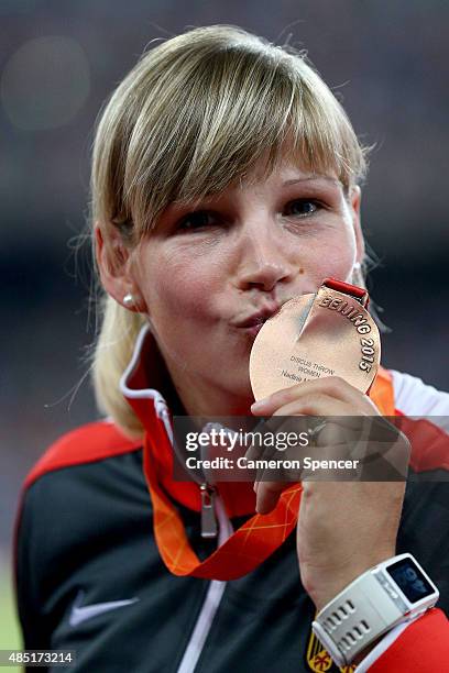 Bronze medalist Nadine Muller of Germany poses during the medal ceremony for the Women's Discus final during day four of the 15th IAAF World...