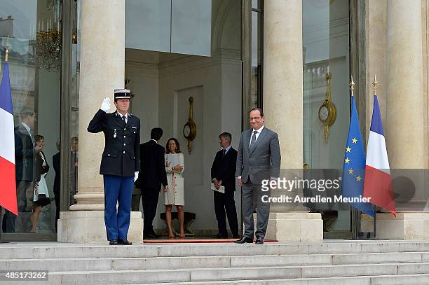 French President Francois Hollande looks on as United Nations Secretary General Ban Ki-Moon leaves the Elysee Palace after a lunch on August 25, 2015...
