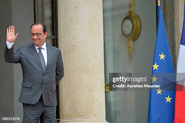 French President Francois Hollande looks on as United Nations Secretary General Ban Ki-Moon leaves the Elysee Palace after a lunch on August 25, 2015...