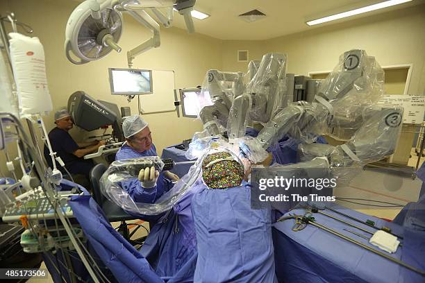 Pierrie van Vollenhoven and Dr Gawie Bruwer doing a robotic surgery on a patient at the Durbanville Mediclinic on August 22, 2015 in Cape Town, South...