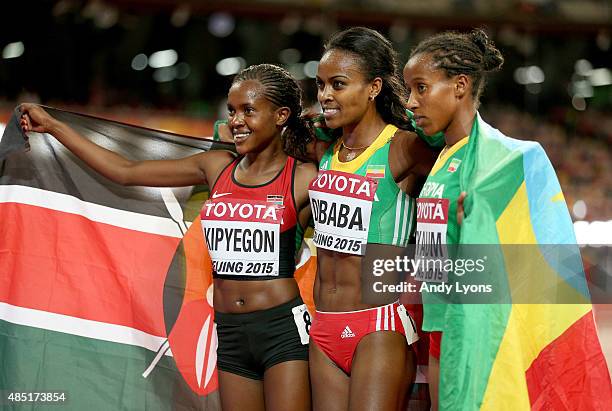 Silver medalist Faith Chepngetich Kipyegon of Kenya, gold medalist Genzebe Dibaba of Ethiopia and Dawit Seyaum of Ethiopia celebrate after the...