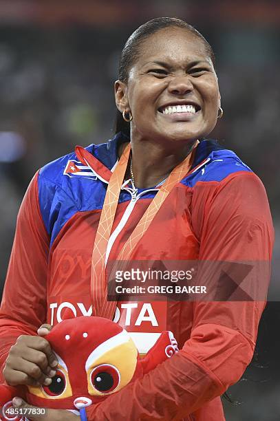 Cuba's Denia Caballero celebrates after winning the final of the women's discus throw athletics event at the 2015 IAAF World Championships at the...