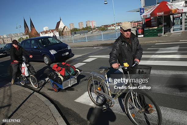 People with bicycles and traffic arrive in Poland as they cross the bridge that connects the Polish town of Slubice and the German city of Frankfurt...