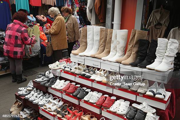 German visitors shop for textiles and shoes that are cheaper than in Germany at an outdoor market near the German-Polish border on April 16, 2014 in...