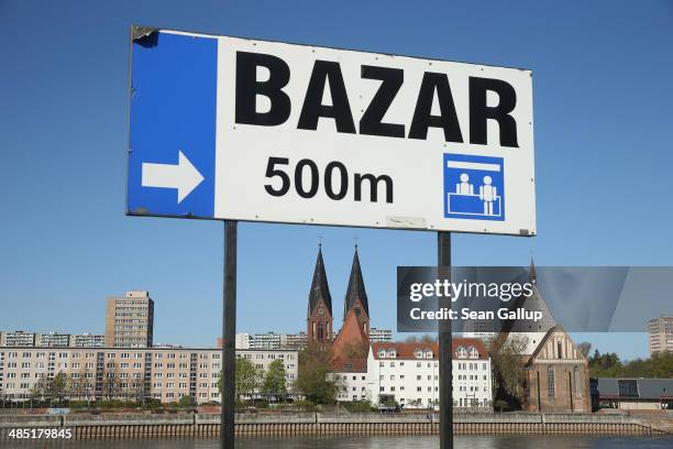 Sign points the way to an outdoor market popular with German visitors on the Polish side of the German-Polish border as buildings in the nearby city...