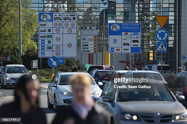 Cars drive past signs explaining Polish highway regulations near the German-Polish border on April 16, 2014 in Slubice, Poland. May 1 will mark ten...